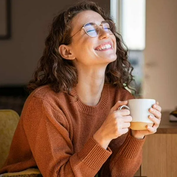 Foto de mujer con taza, en nota de cuántas veces se usa el café en la cafetera: consejos para ajustar sabor perfecto