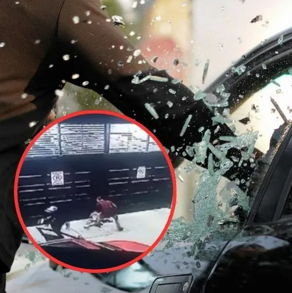 Momento en el que dos ladrones abordan a un conductor en Bogotá y lo despojan de su carro. También lo golpearon