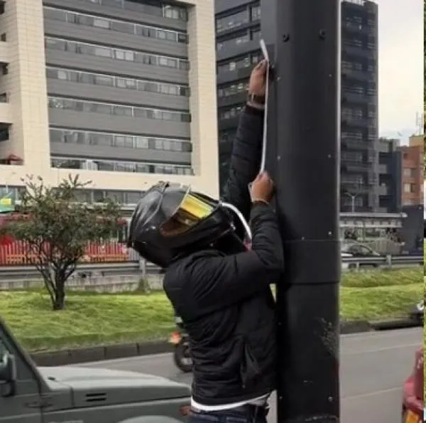 Cámaras de fotomultas en Bogotá están siendo tapadas con cintas por un hombre