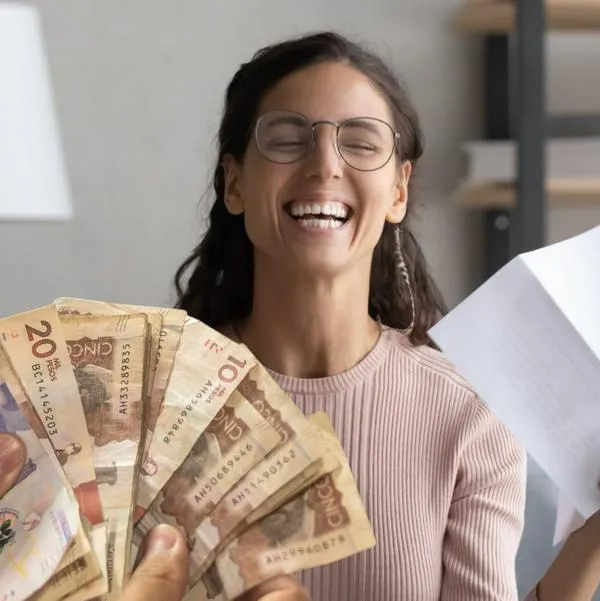 Mujer feliz y dinero de Colombia, en nota sobre que miles en Soacha tendrán rebaja en tarifa de servicio público