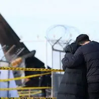 Bereaved family members stand at the scene where a Jeju Air Boeing 737-800 series aircraft crashed and burst into flames at Muan International Airport in Muan, some 288 kilometres southwest of Seoul on December 30, 2024. - The Boeing 737-800 was carrying 181 people from Thailand to South Korea when it crashed on arrival on December 29, killing everyone aboard -- save two flight attendants pulled from the twisted wreckage of the worst aviation disaster on South Korean soil. (Photo by YONHAP / AFP) / - South Korea OUT / NO USE AFTER JANUARY 8, 2025 16:00:00 GMT -  - SOUTH KOREA OUT / NO ARCHIVES -  RESTRICTED TO SUBSCRIPTION USE