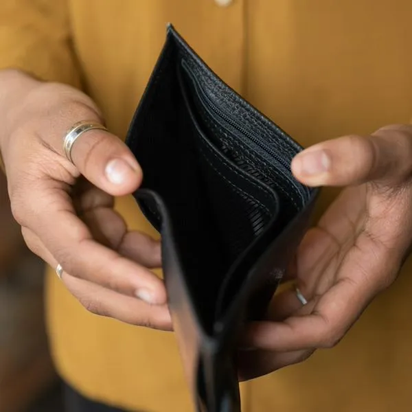 Imagen de referencia de trabajador mostrando billetera vacía.