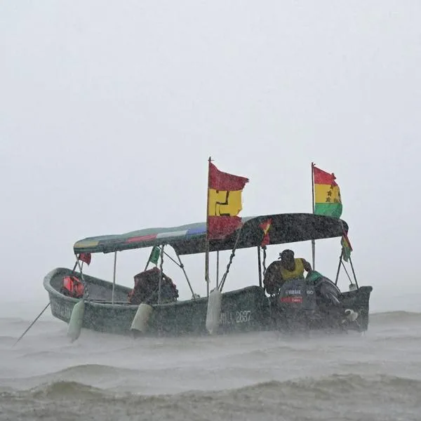 A boat of indigenous Gunas sails under heavy rain and wind in the port of Carti, Guna Yala territory, Panama on 22 February 2025. (Photo by MARTIN BERNETTI / AFP)