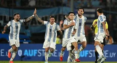 Argentina's midfielder #11 Thiago Almada (3rd R) celebrates with teammates after scoring during the 2026 FIFA World Cup South American qualifiers football match between Uruguay and Argentina at the Centenario stadium in Montevideo, on March 21, 2025. (Photo by Eitan ABRAMOVICH / AFP)