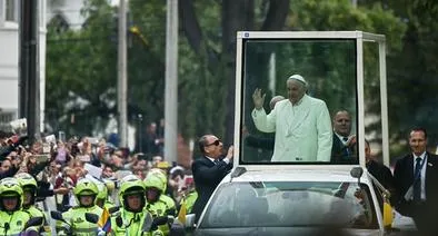 Pope Francis waves from the popemobile as he leaves the nunciature for the CATAM military airport on his way to Cartagena, on September 10, 2017, in Bogota on his last day in the country. (Photo by LUIS ROBAYO / AFP)