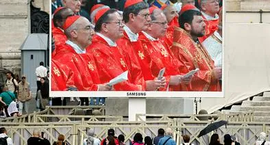 VATICAN CITY, VATICAN - MAY 07: Cardinals are shows on screen as people gather in St. Peter's Square and watch the Mass for the Election of the New Pope on screens before the start of the conclave on May 07, 2025 in Vatican City, Vatican. Cardinals of the Catholic Church have descended on Vatican City to commence the papal conclave, the secretive voting process held in the Sistine Chapel that requires a two-thirds majority to elect the new leader of the Catholic Church. The election follows the death of Pope Francis on April 21 at the age of 88. (Photo by Mario Tama/Getty Images)