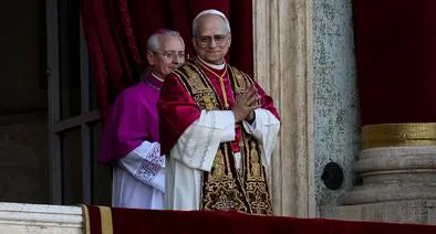VATICAN CITY, VATICAN - MAY 8: The newly elected Pontiff, Pope Leo XIV is seen for the first time from the Vatican balcony on May 8, 2025 in Vatican City, Vatican. Cardinal Robert Prevost will be known as Pope Leo XIV. White smoke was seen over the Vatican early this evening as the Conclave of Cardinals took just two days to elect the new Pontiff after the death of Pope Francis on Easter Monday. (Photo by Antonio Masiello/Getty Images)