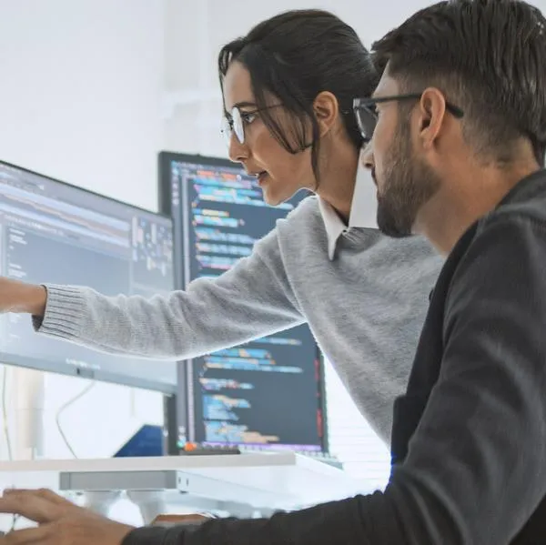 Hispanic Latin American couple, software engineer developer use computer, work on program coding together at home office. Programming language development technology, freelance job concept