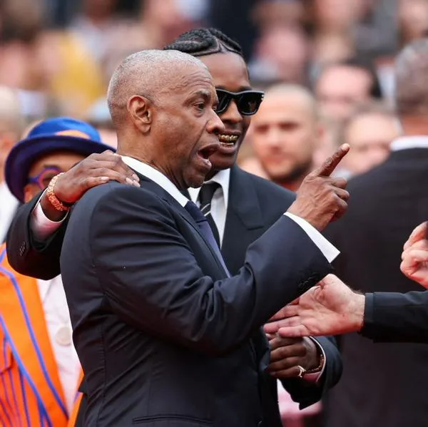 US actor Denzel Washington argues with a photographer next to US singer and actor ASAP Rocky as they arrive for the screening of the film "Highest 2 Lowest" at the 78th edition of the Cannes Film Festival in Cannes, southern France, on May 19, 2025. (Photo by Sameer AL-DOUMY / AFP)