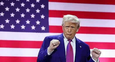 DOHA, QATAR - MAY 15: U.S. President Donald J. Trump gestures on stage as he tours the Al Udeid Air Base on May 15, 2025, in Doha, Qatar. Trump is on the third day of his visit to the Gulf to underscore the strategic partnership between the United States and Qatar, focusing on regional security and economic collaboration.  (Photo by Win McNamee/Getty Images)
