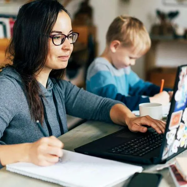 Foto de madre en teletrabajo, en nota de cómo conseguir trabajo remoto en Colombia para madres con curso gratis en agosto