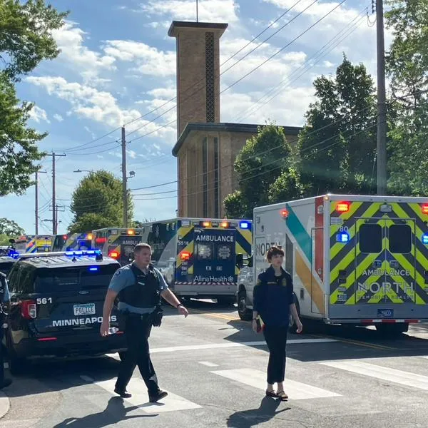 Police and first responders work at the scene of a shooting near Annunciation Church and Catholic School in Minneapolis, Minneosta, on August 27, 2025. Two children were shot dead when a gunman attacked a Minneapolis church on Wednesday, with 17 people injured, 14 of them children, police said. The gunman "began firing a rifle through the church windows towards the children sitting in the pews at the mass," Minneapolis police chief Brian O'Hara told reporters. The pupils were marking the first week of the school year when the attack occurred. (Photo by Tom BAKER / AFP)