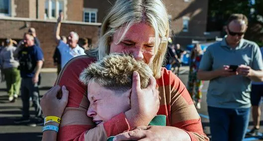 A parent hugs her son during an active shooter situation at the Annunciation Church in Minneapolis, Minn., on Wednesday, Aug. 27, 2025.] (Photo by RICHARD TSONG-TAATARII/The Star Tribune via Getty Images)