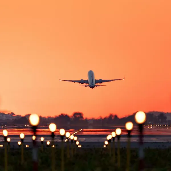 Airplane taking off at sunrise,