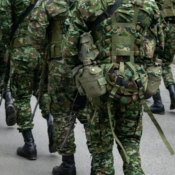 Colombian army patrolling the streets, military forces on urban patrol in Colombia, soldiers securing the streets in Colombia, army troops conducting street patrol, Colombian military presence in urban areas. High quality photo