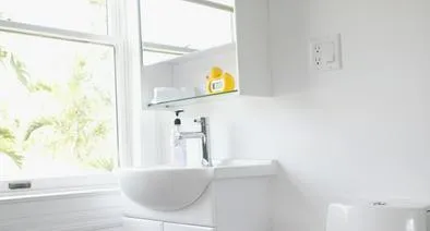 "Toilet, sink and mirror in modern bathroom"