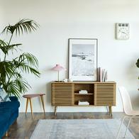 Computer at table in apartment. Bright modern room with furniture. Interior of home office.