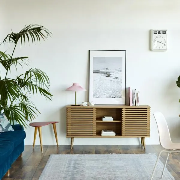 Computer at table in apartment. Bright modern room with furniture. Interior of home office.