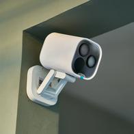 White security camera mounted on a wall, continuously monitoring the room and providing enhanced safety and surveillance through cutting-edge technology and smart design