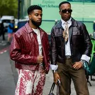 LONDON, ENGLAND - SEPTEMBER 17: A guest (L) wears a red distressed leather jacket, a white t-shirt, red and white splatter pattern trousers, and a gold chain outside Mark Fast on September 17, 2026 in London, England. (Photo by Christian Vierig/Getty Images)