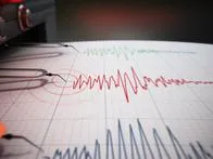 Seismograph printing seismic activity records of a severe earthquake.