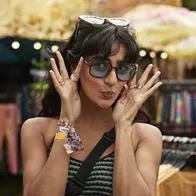 Happy woman puckering while wearing sunglasses at market stall