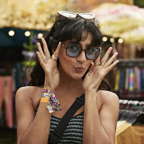 Happy woman puckering while wearing sunglasses at market stall