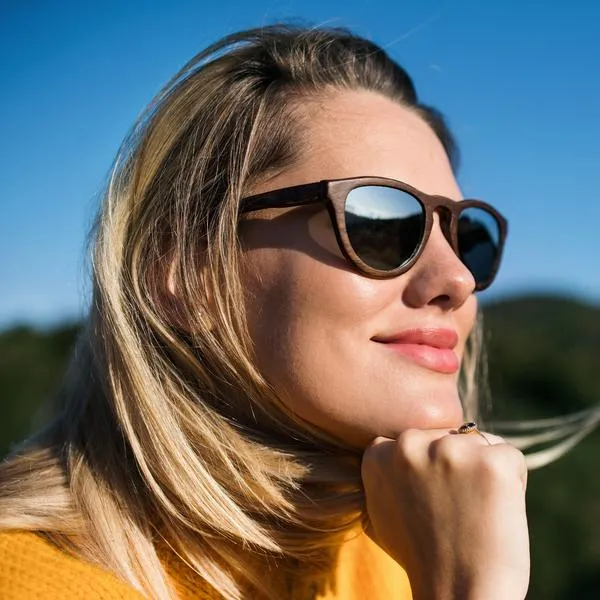An attractive blond woman sunglasses on a walk. Copy space.