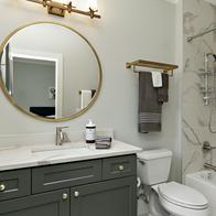 This images shows a modern bathroom with all new white paint and new marble tiles.
