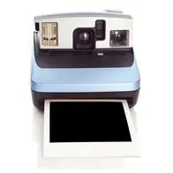 Metalic blue colored Instant film camera with a blank instant print photo from 90's on white background