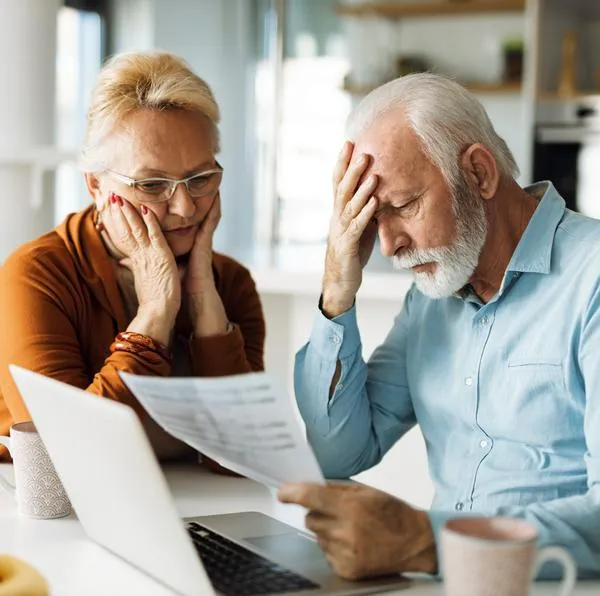 Worried senior couple feeling stressed while have to pay their bills over Internet