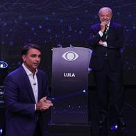 Lula da Silva (atrás) y Flávio Bolsonaro (adelante) durante un debate de las elecciones presidenciales de Brasil