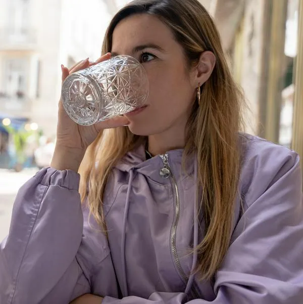Sparkling or still water, soft drinks, mineral water or hydration options by drinking from a glass. Close view.